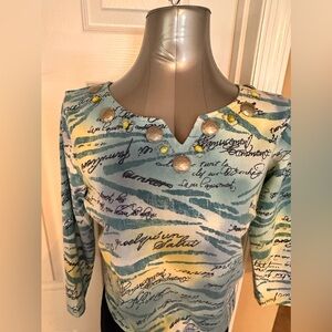 Women’s 3/4 length sleeves shirt with jewel neck.